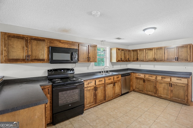 kitchen featuring sink, black appliances, a textured ceiling, and light tile patterned floors