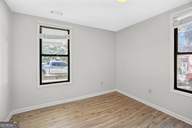 unfurnished room with light wood-type flooring