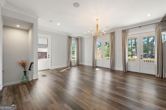 unfurnished room with french doors, a healthy amount of sunlight, and dark wood-type flooring