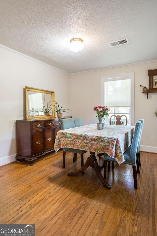 5605 Ga Highway 121, Blackshear, GA 31516 - dining room featuring ornamental molding, a textured ceiling, light wood-style floors, and baseboards