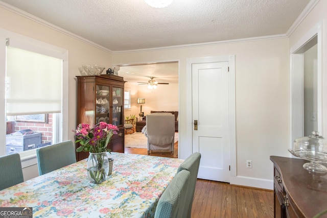 5605 Ga Highway 121, Blackshear, GA 31516 - dining space with crown molding, hardwood / wood-style floors, ceiling fan, a textured ceiling, and baseboards