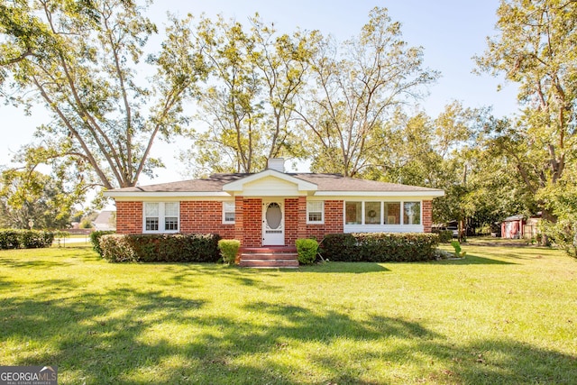 5605 Ga Highway 121, Blackshear, GA 31516 - view of front facade with a front lawn, a chimney, and brick siding