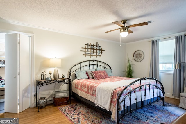 5605 Ga Highway 121, Blackshear, GA 31516 - bedroom with ornamental molding, wood finished floors, a textured ceiling, and ceiling fan