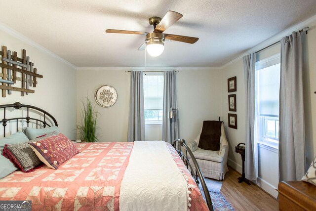 5605 Ga Highway 121, Blackshear, GA 31516 - bedroom featuring multiple windows, wood finished floors, crown molding, and a ceiling fan