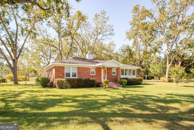 5605 Ga Highway 121, Blackshear, GA 31516 - view of front of home featuring brick siding, a front yard, and a chimney