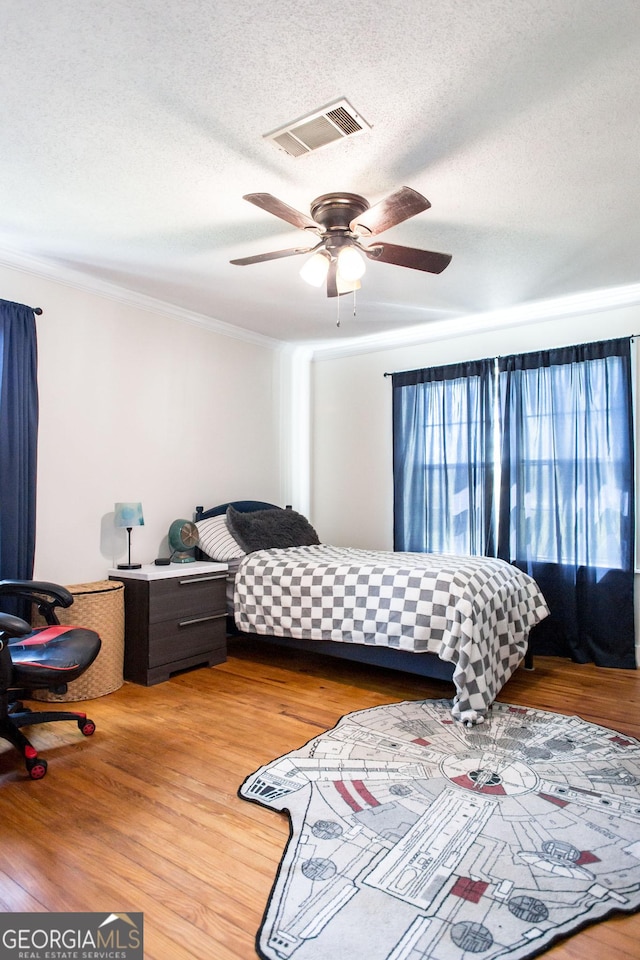 5605 Ga Highway 121, Blackshear, GA 31516 - bedroom featuring ornamental molding, a textured ceiling, wood finished floors, and a ceiling fan