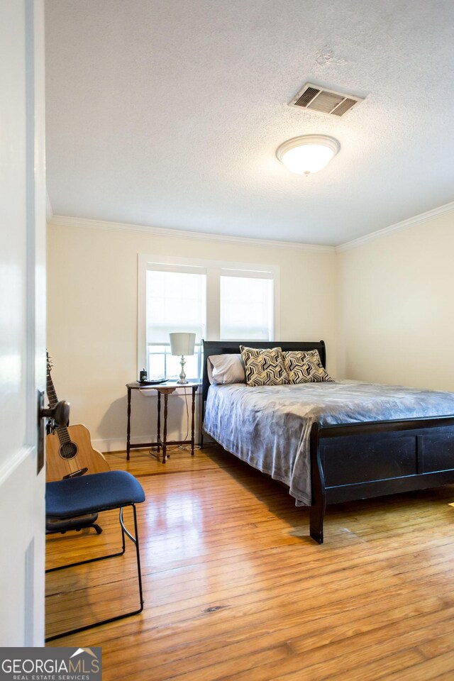 5605 Ga Highway 121, Blackshear, GA 31516 - bedroom with ornamental molding, wood finished floors, and a textured ceiling