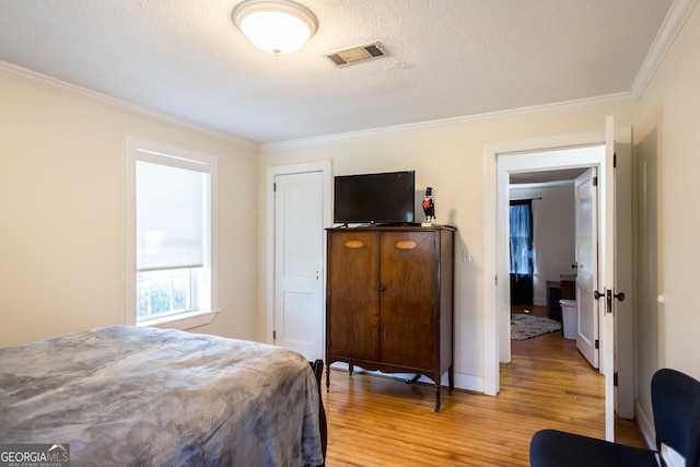 5605 Ga Highway 121, Blackshear, GA 31516 - bedroom featuring light wood finished floors, ornamental molding, baseboards, and a textured ceiling