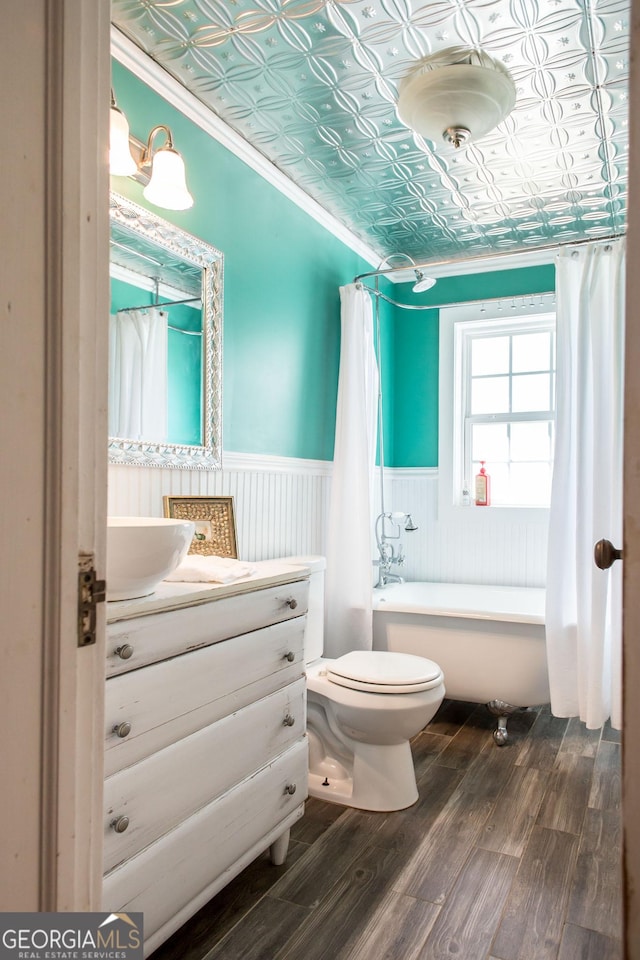 5605 Ga Highway 121, Blackshear, GA 31516 - bathroom featuring a wainscoted wall, an ornate ceiling, toilet, vanity, and wood finished floors