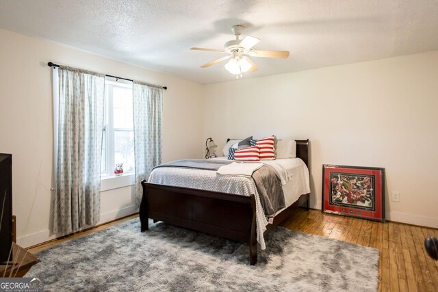 5605 Ga Highway 121, Blackshear, GA 31516 - bedroom featuring hardwood / wood-style floors, baseboards, a ceiling fan, and a textured ceiling