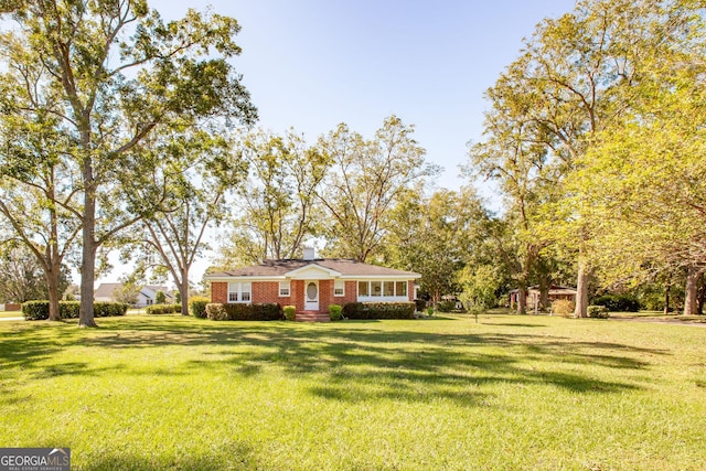 5605 Ga Highway 121, Blackshear, GA 31516 - view of front of property featuring a front yard, brick siding, and a chimney