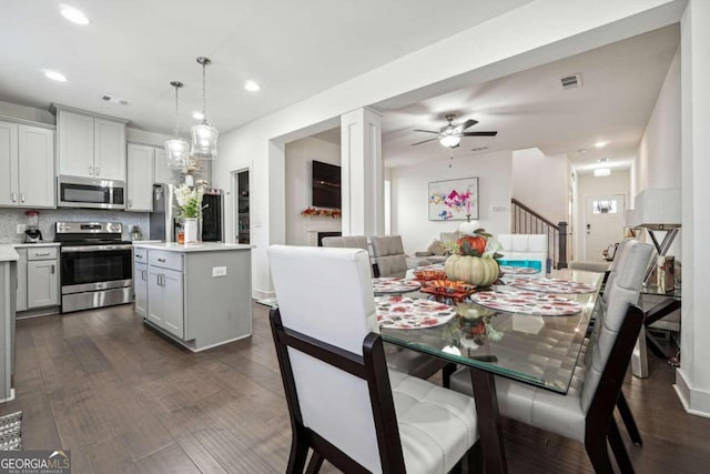 dining room featuring ceiling fan and dark hardwood / wood-style floors