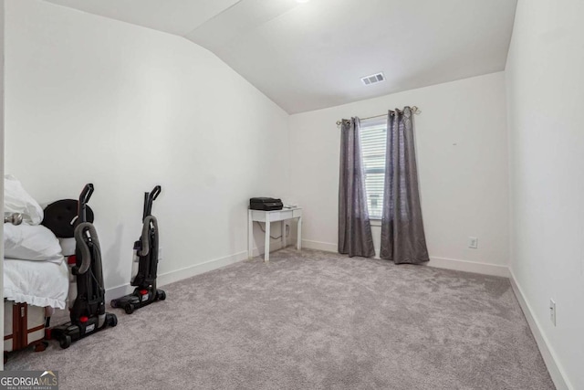 interior space with vaulted ceiling and light colored carpet