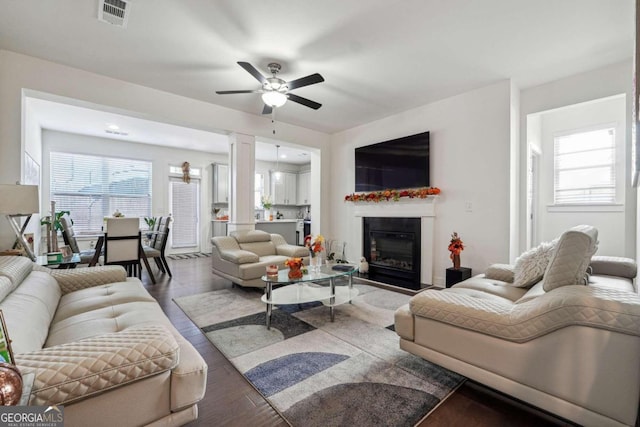 living room with wood-type flooring and ceiling fan