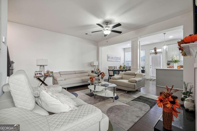 living room with dark wood-type flooring and ceiling fan