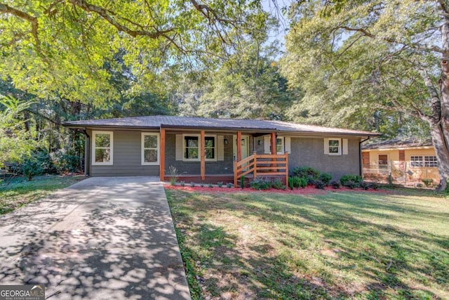 ranch-style home with covered porch and a front lawn