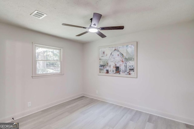 unfurnished room featuring ceiling fan, a textured ceiling, and light hardwood / wood-style flooring