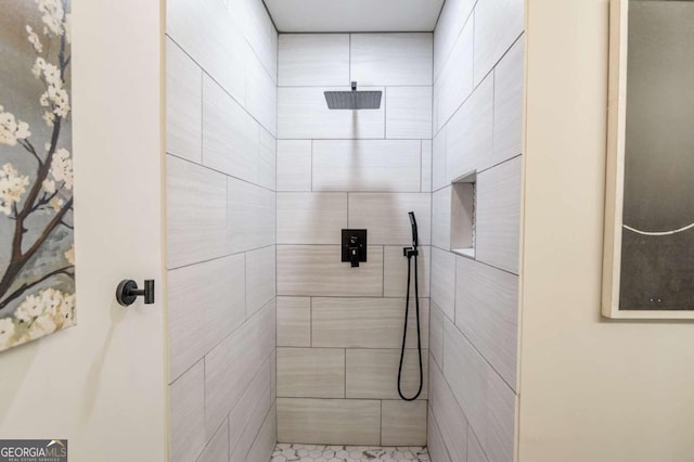 bathroom with a tile shower