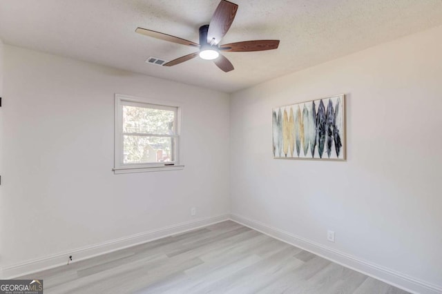 unfurnished room featuring light hardwood / wood-style floors, a textured ceiling, and ceiling fan