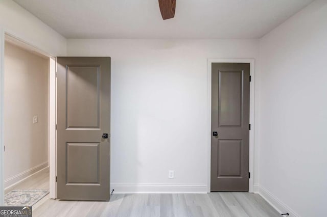 empty room featuring light hardwood / wood-style flooring and ceiling fan