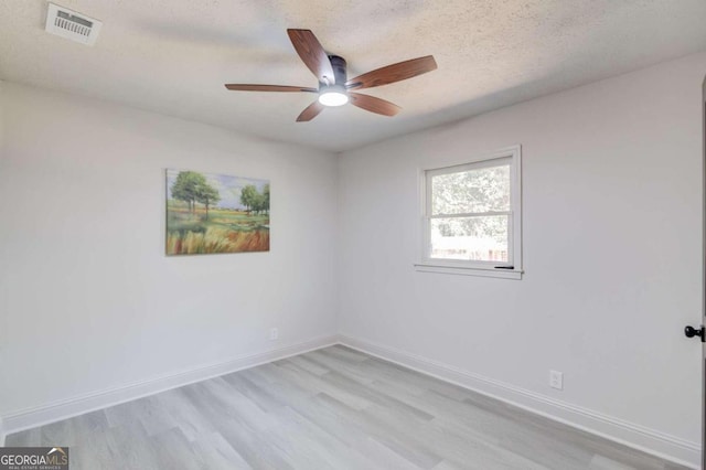 unfurnished room featuring light hardwood / wood-style floors, a textured ceiling, and ceiling fan