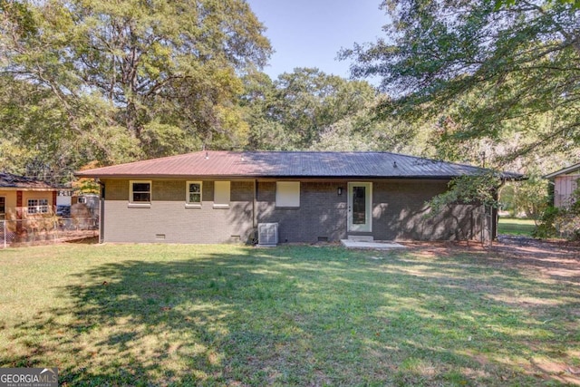 back of house with a lawn