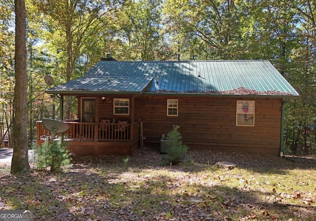 back of property featuring a wooden deck