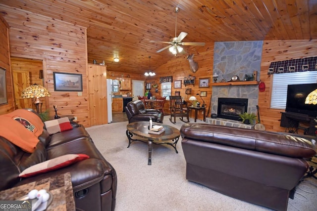 carpeted living room featuring a stone fireplace, wooden walls, and wooden ceiling