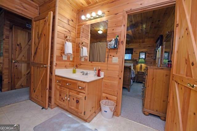 bathroom featuring wood walls, wood ceiling, tile patterned floors, a shower with curtain, and vanity