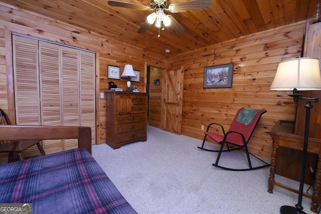 carpeted bedroom featuring a closet, wood ceiling, wood walls, and ceiling fan