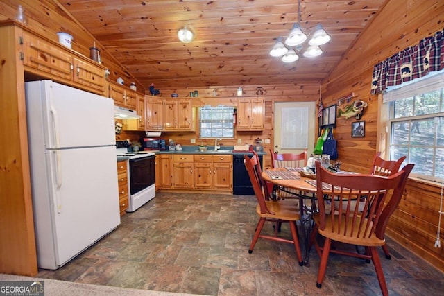 kitchen with lofted ceiling, wooden walls, sink, pendant lighting, and white appliances