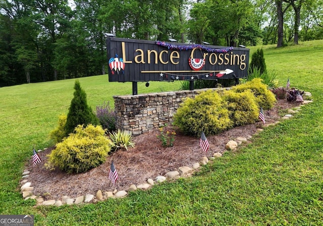 community / neighborhood sign with a lawn