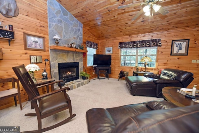 carpeted living room featuring wood walls, a fireplace, wood ceiling, ceiling fan, and high vaulted ceiling