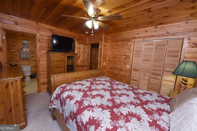 bedroom featuring ensuite bathroom, carpet floors, a closet, ceiling fan, and wooden ceiling