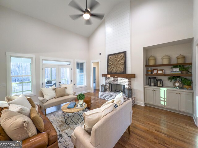 kitchen with gray cabinets, a center island with sink, pendant lighting, and dark hardwood / wood-style floors