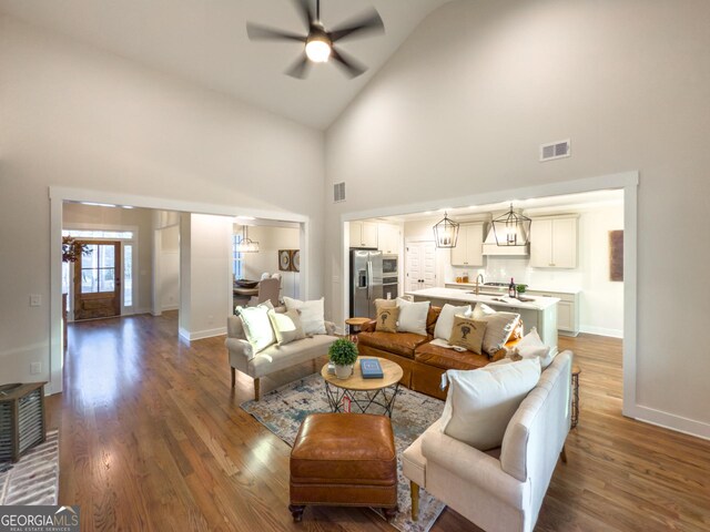 kitchen with a kitchen island with sink, appliances with stainless steel finishes, and decorative light fixtures