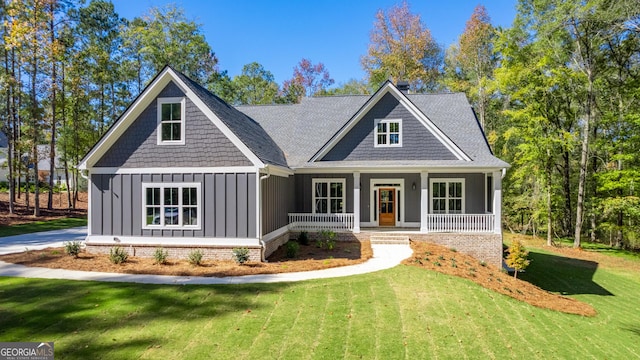 craftsman inspired home with a front yard and a porch