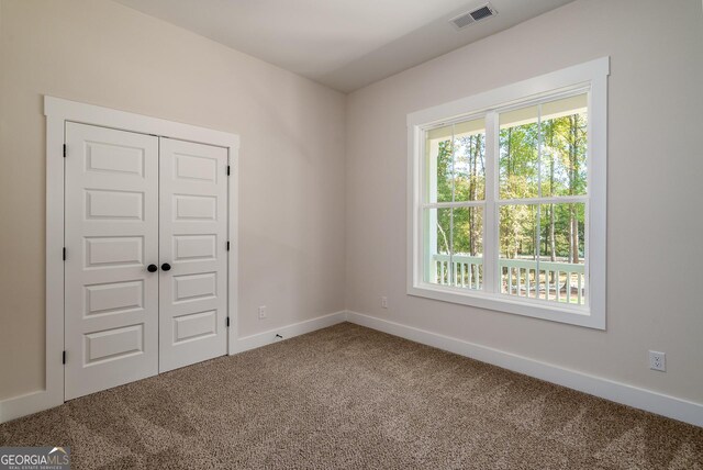 unfurnished room featuring carpet flooring