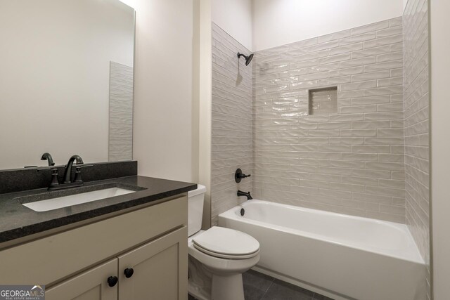 bathroom featuring toilet, vanity, and tile patterned floors