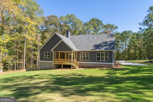 1169 Dean Hill Rd, Monroe, GA 30655 - rear view of house with a chimney, a lawn, roof with shingles, and a sunroom