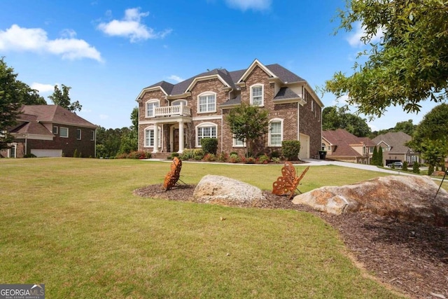 front facade featuring a front yard and a balcony