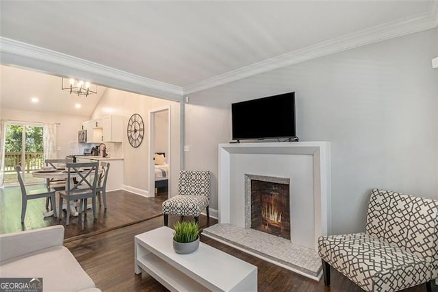 living room with dark wood-type flooring, crown molding, lofted ceiling, and an inviting chandelier