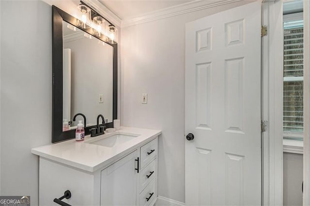 bathroom with vanity, crown molding, and a healthy amount of sunlight