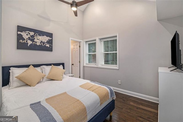 bedroom featuring dark hardwood / wood-style floors, a towering ceiling, and ceiling fan