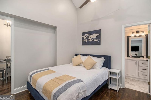 bedroom featuring sink, ensuite bath, ceiling fan, lofted ceiling, and dark hardwood / wood-style floors