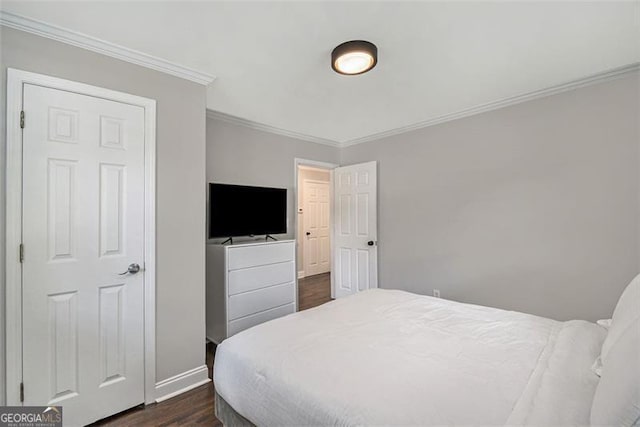 bedroom with ornamental molding and dark wood-type flooring