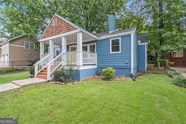 bungalow-style home with a porch and a front lawn