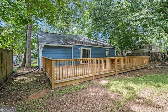 rear view of house featuring a deck