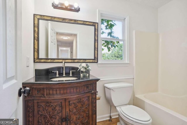 full bathroom featuring toilet, vanity, and  shower combination