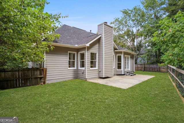 rear view of property with a patio area and a lawn